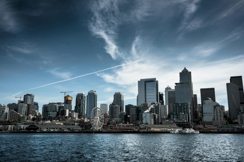Dramatic view of the Seattle skyline featuring the waterfront and iconic Ferris wheel.